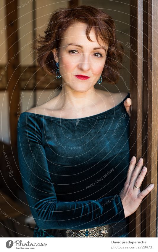 Portrait of a mature woman posing thoughtful throughout the window Portrait photograph Woman Red-haired Mature Old Human being Window Considerate Stand