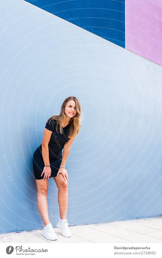 Happy beautiful young woman posing by a colorful wall Woman Multicoloured Blonde Smiling Fashion Model Red Youth (Young adults) Stand Face Girl Loneliness