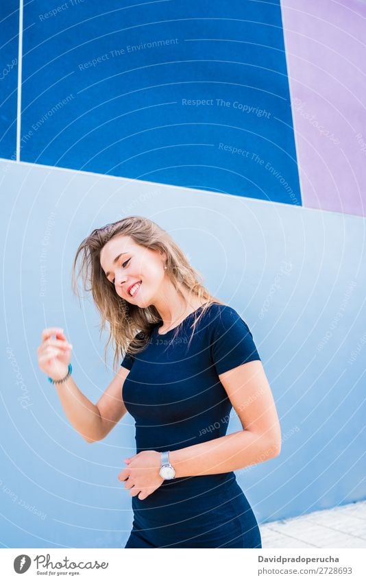 Happy beautiful young woman posing by a colorful wall Woman Multicoloured Blonde Smiling Fashion Model Red Youth (Young adults) Stand Face Girl Loneliness