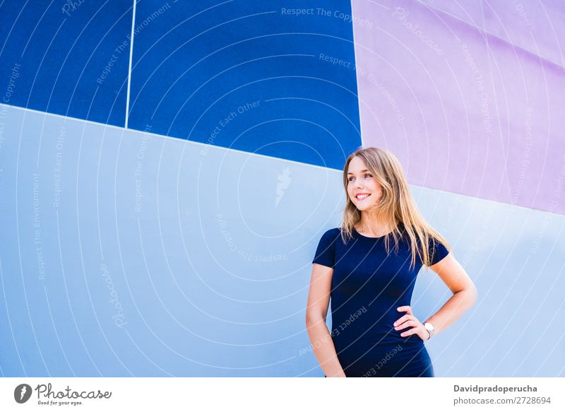 Happy beautiful young woman posing by a colorful wall Woman Multicoloured Blonde Smiling Fashion Model Red Youth (Young adults) Stand Face Girl Loneliness