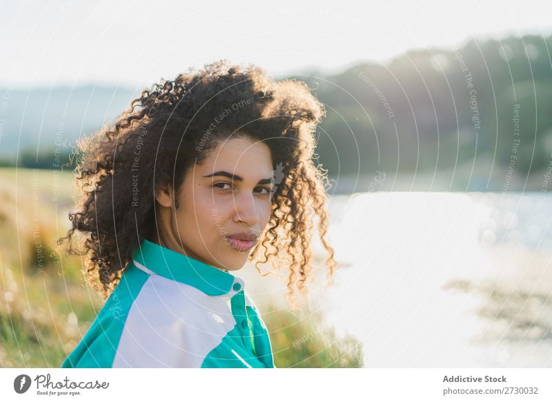 Curly woman posing on nature in sunlight Woman Summer To enjoy Posture human face Landscape Nature Colour Portrait photograph tranquil Exterior shot Countries