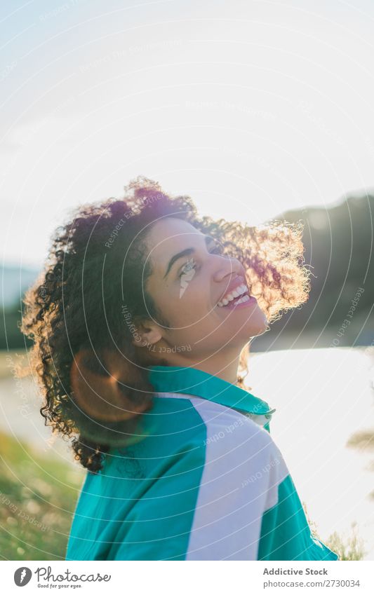 Curly woman posing on nature in sunlight Woman Summer To enjoy Posture human face Landscape Nature Colour Portrait photograph tranquil Exterior shot Countries