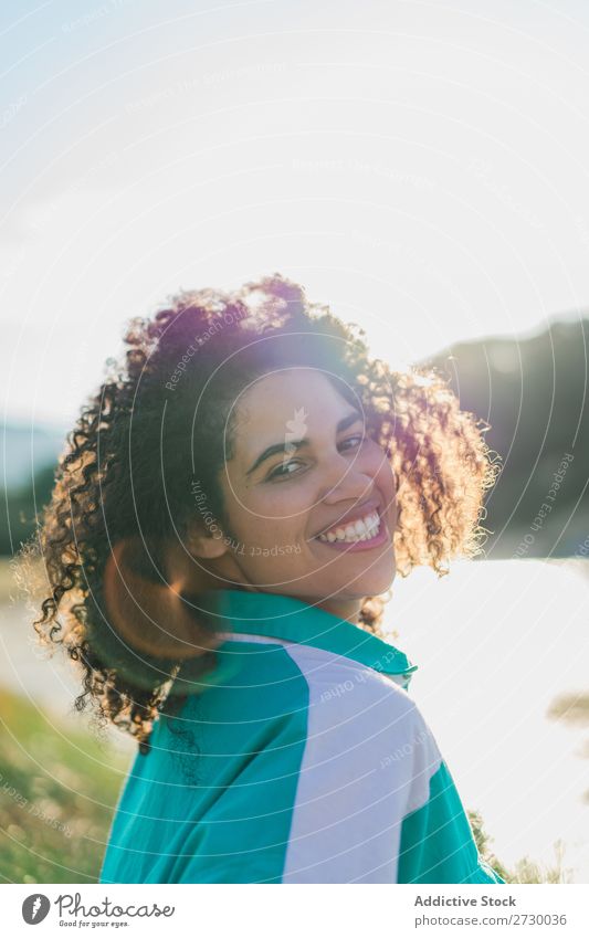 Curly woman posing on nature in sunlight Woman Summer To enjoy Posture human face Landscape Nature Colour Portrait photograph tranquil Exterior shot Countries