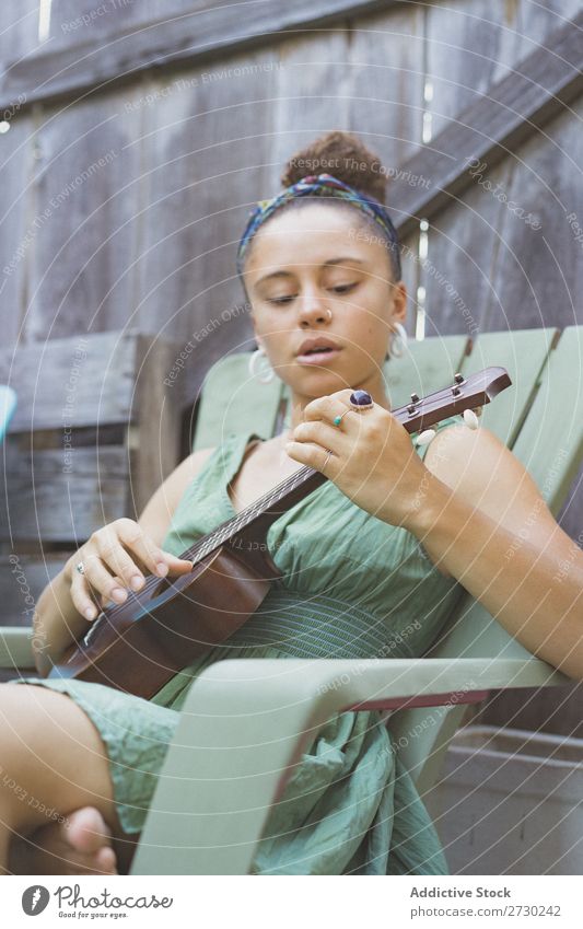 Girl playing ukulele in garden chair Woman Ukulele Musician Garden Relaxation Summer Guitar instrument Beautiful Youth (Young adults) Artist Lifestyle