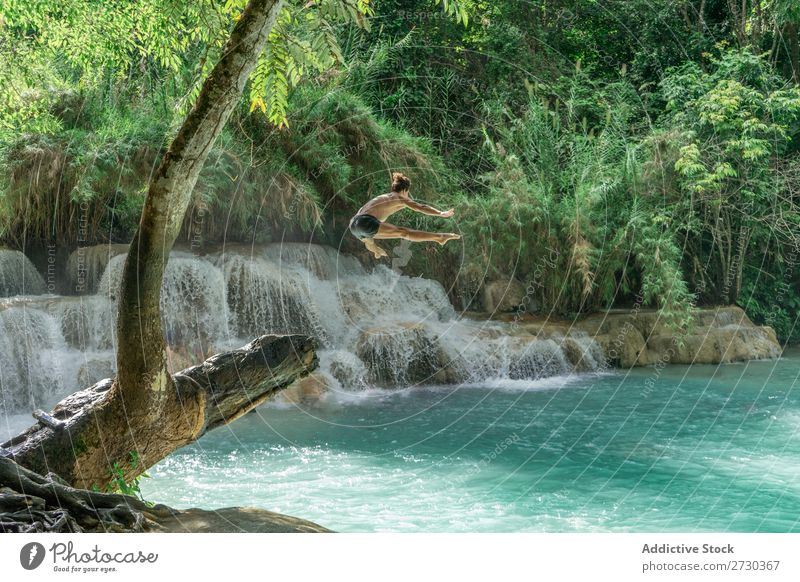 Man jumping to turquoise water Acrobat Nature Extreme Acrobatic shirtless Jump Story mid-air Water Lake Blue Healthy Lifestyle Sports Posture Adventure Strong