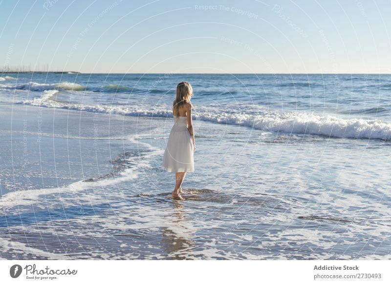 Bride walking on shore in sunlight Woman Beach Wedding Movement Blue sky Nature long hair romantic Natural Beauty Photography Dress White Love Summer Blonde