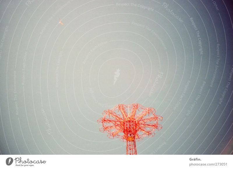 Until unrecognizable and much further Amusement Park Sky Cloudless sky Large Infinity Retro Trashy Blue Red Loneliness Stagnating Decline Carousel Colour photo