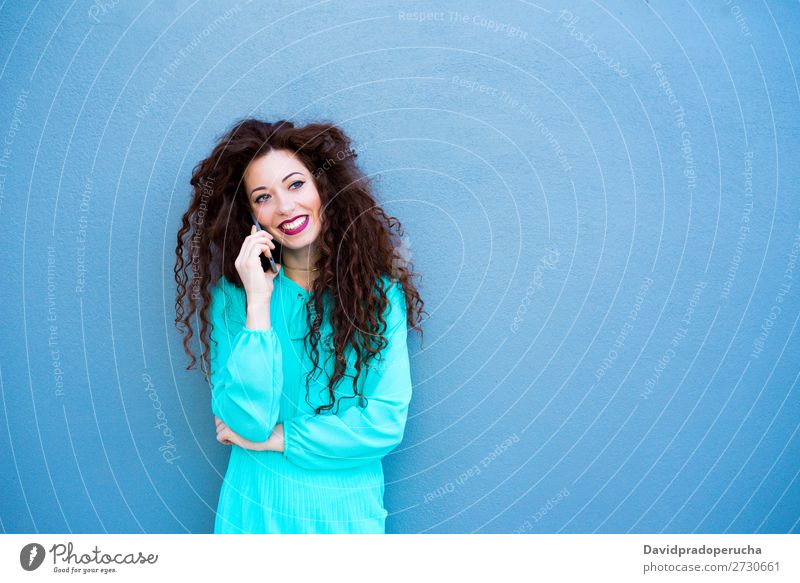 Happy young woman on the mobile phone by a colorful wall Woman Red-haired Telephone Business Businesswoman Technology Mobile Smiling Face Beauty Photography