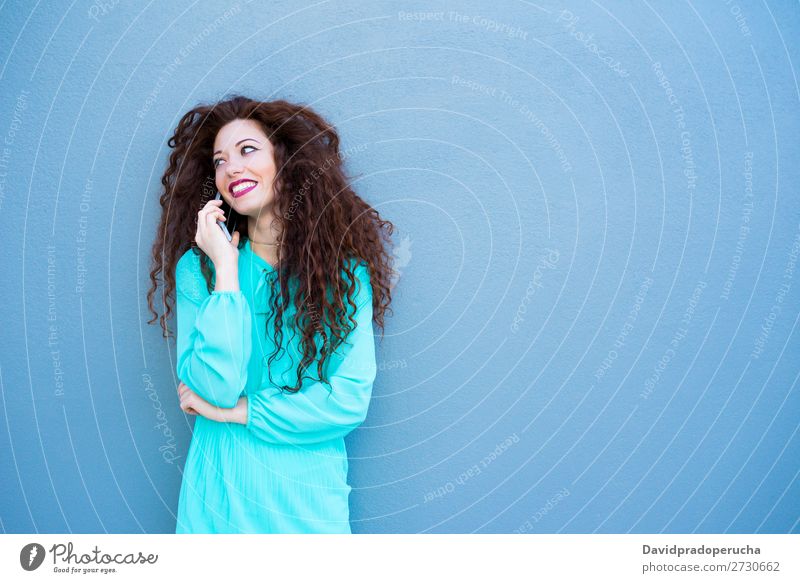 Happy young woman on the mobile phone by a colorful wall Woman Red-haired Telephone Business Businesswoman Technology Mobile Smiling Face Beauty Photography