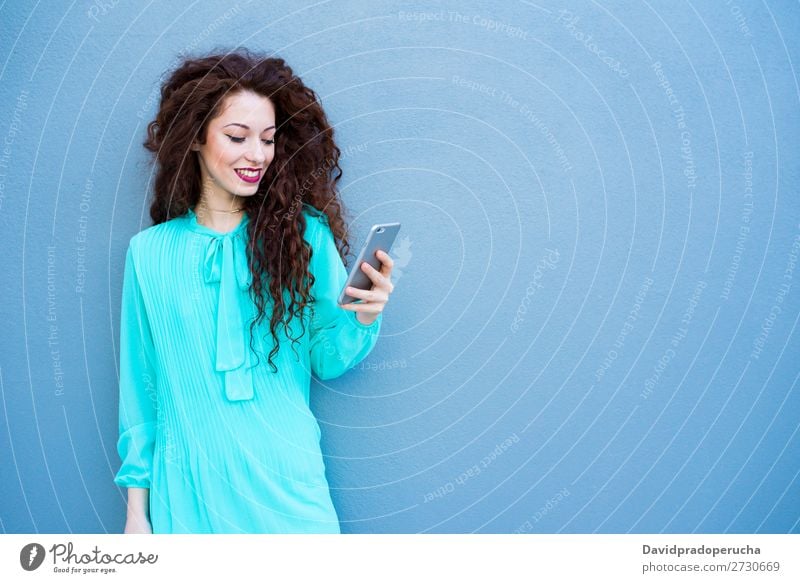 Happy young woman on the mobile phone by a colorful wall Woman Red-haired Telephone Business Businesswoman Technology Mobile Smiling Face Beauty Photography