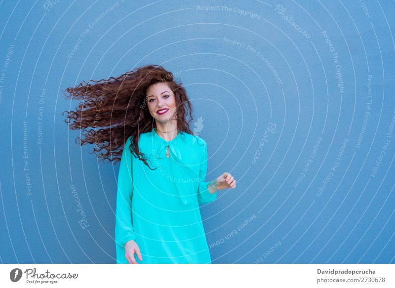 Happy beautiful young redhead woman posing by a colorful wall Woman Red-haired Smiling Face Beauty Photography Girl Ginger Curly Loneliness Portrait photograph