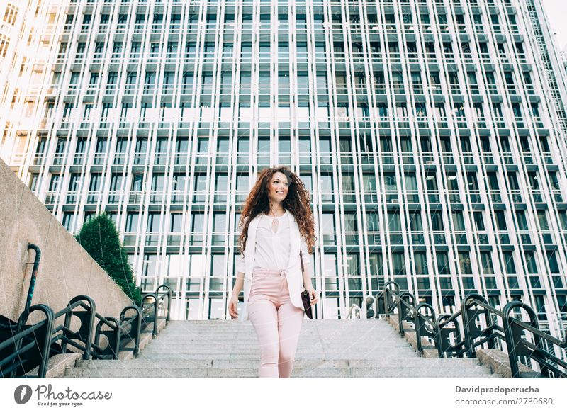 Young redhead business woman walking on the stairs Woman Red-haired Business Businesswoman Technology Work and employment Walking Stairs Suit Pink boss Lady