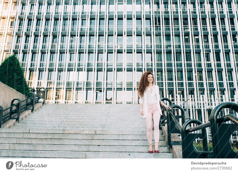 Young redhead business woman walking on the stairs Woman Red-haired Business Businesswoman Technology Work and employment Walking Stairs Suit Pink boss Lady