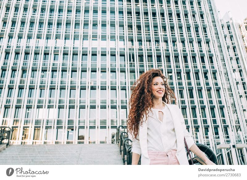 Young redhead business woman walking on the stairs Woman Red-haired Business Businesswoman Technology Work and employment Walking Stairs Suit Pink boss Lady