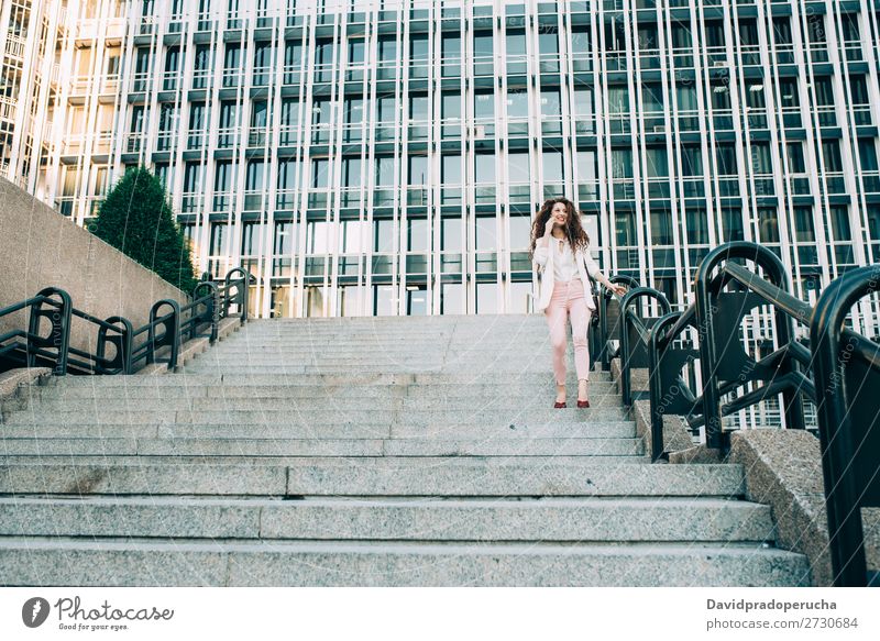 Young redhead business woman walking on the stairs Woman Red-haired Business Businesswoman Technology Work and employment Walking Stairs Suit Pink boss Lady