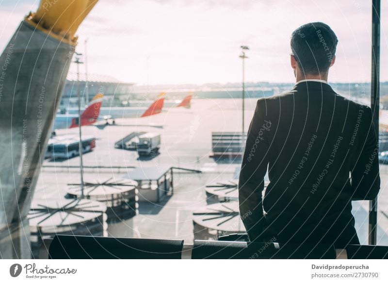 Back of a young business man standing with the suitcase at the airport waiting for the flight Airport Man Vacation & Travel Shadow Business Wait Airplane Gate