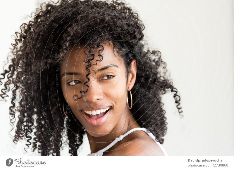 Portrait of a beautiful young black woman looking into camera Woman Portrait photograph Close-up Black Smiling Beautiful Cute pretty Skin Afro