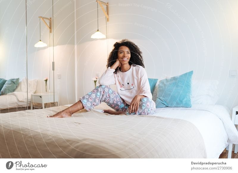 Happy beautiful young black woman relaxed sitting in the bed Woman Black Smiling Relaxation Beautiful awake Cute Bed Cozy Pyjama pajama Winter Cold Sit