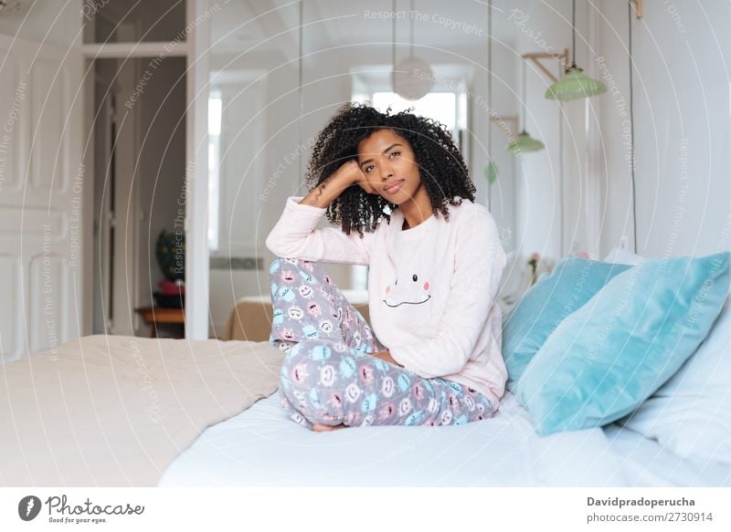 Happy beautiful young black woman relaxed sitting in the bed Woman Black Smiling Relaxation Beautiful awake Cute Bed Cozy Pyjama pajama Winter Cold Sit