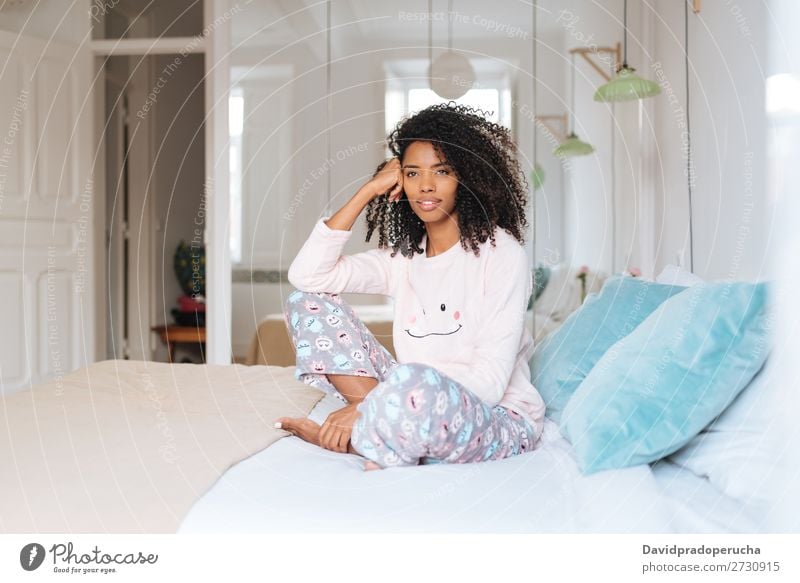 Happy beautiful young black woman relaxed sitting in the bed Woman Black Smiling Relaxation Beautiful awake Cute Bed Cozy Pyjama pajama Winter Cold Sit