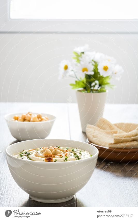 Hummus in bowl and pita bread on wood Bread Food Healthy Eating Food photograph Dish Nutrition Chickpeas Coriander Lemon Olive oil Vegan diet Arabia tahini Bowl