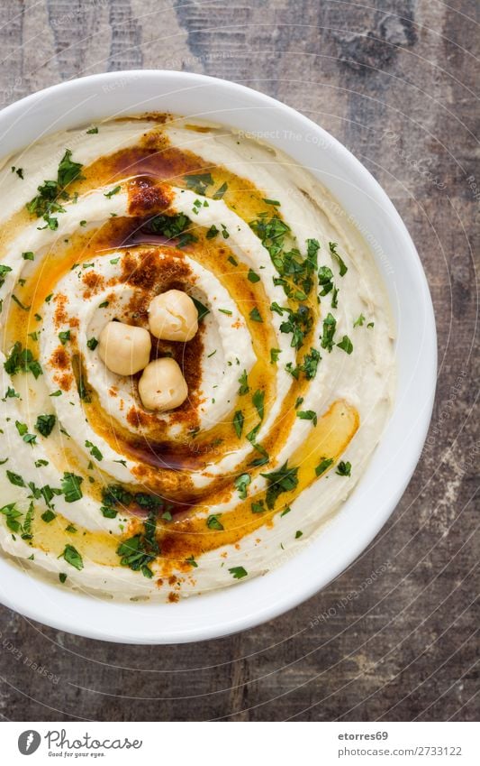 Hummus in bowl on wooden table Food Healthy Eating Food photograph Nutrition Chickpeas Coriander Lemon Olive oil Vegan diet arabic tahini Bowl Dip Fresh