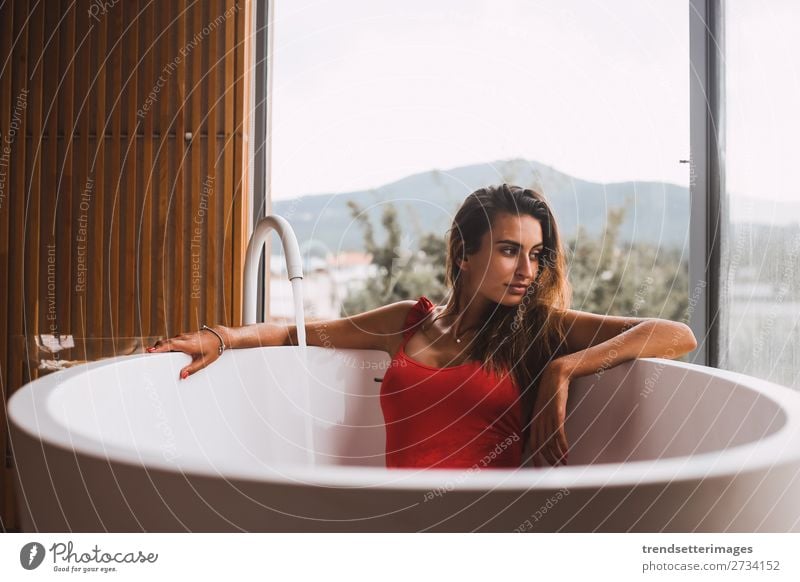 Woman in a modern bath tub Lifestyle Luxury Beautiful Body Skin Wellness Relaxation Spa Bathtub Bathroom Adults Flower To enjoy Modern Clean young girl Tub care