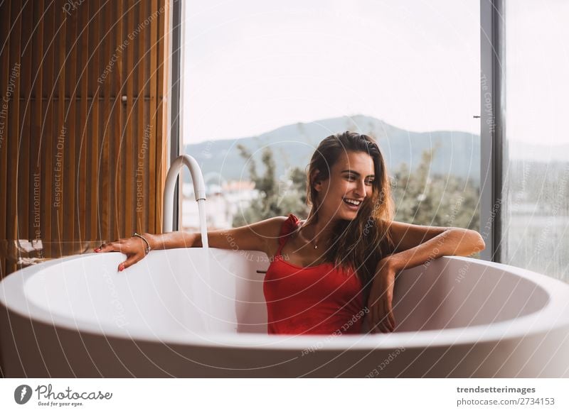 Woman in a modern bath tub Lifestyle Luxury Beautiful Body Skin Wellness Relaxation Spa Bathtub Bathroom Adults Flower To enjoy Modern Clean young girl Tub care