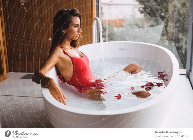 Woman in a modern bath tub Lifestyle Luxury Beautiful Body Skin Wellness Relaxation Spa Bathtub Bathroom Adults Flower To enjoy Modern Clean young girl Tub care