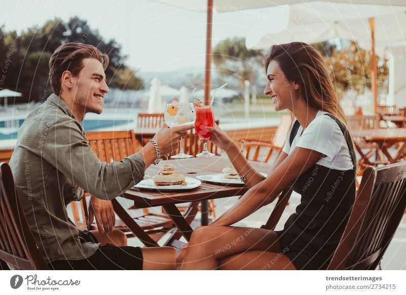 Couple drinking cocktails Drinking Juice Alcoholic drinks Lifestyle Joy Happy Beautiful Swimming pool Vacation & Travel Summer Sun Restaurant Woman Adults Man