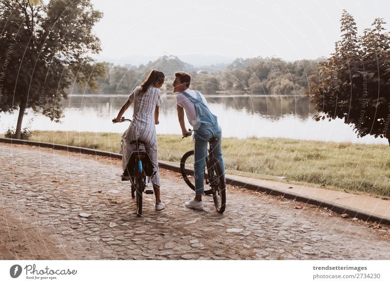 Romantic couple riding bicycles Lifestyle Joy Happy Beautiful Leisure and hobbies Woman Adults Man Family & Relations Couple Nature Landscape Autumn Street