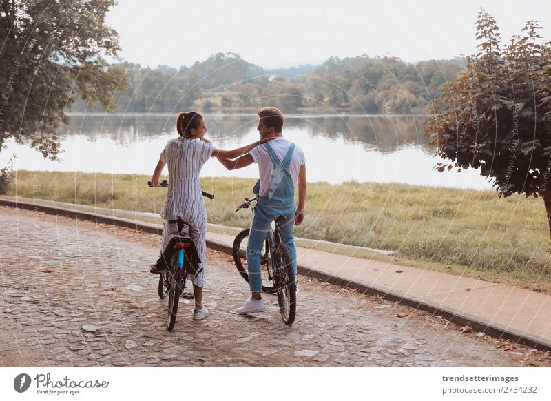 Romantic couple riding bicycles Lifestyle Joy Happy Beautiful Leisure and hobbies Woman Adults Man Family & Relations Couple Nature Landscape Autumn Street