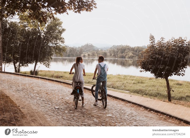 Romantic couple riding bicycles Lifestyle Joy Happy Beautiful Leisure and hobbies Woman Adults Man Family & Relations Couple Nature Landscape Autumn Street