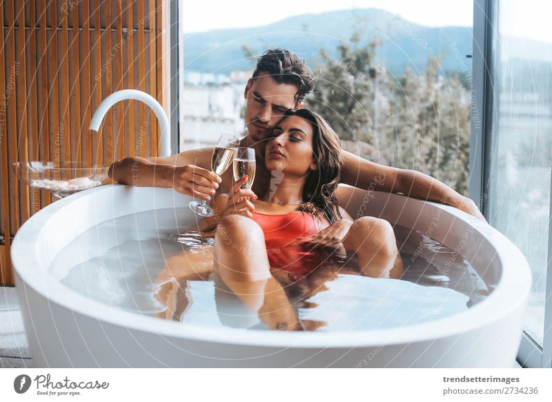 Couple enjoying a bath with champagne Alcoholic drinks Lifestyle Luxury Happy Beautiful Wellness Relaxation Spa Leisure and hobbies Vacation & Travel Woman