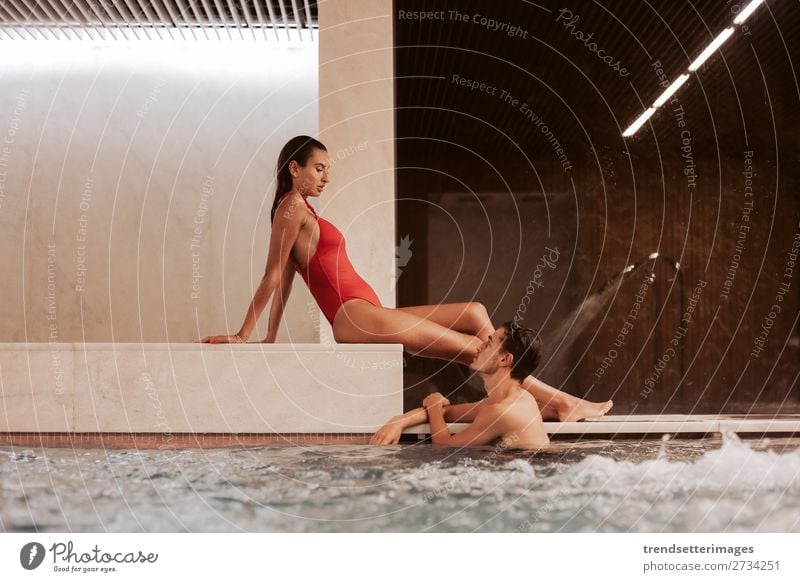 Couple In Love At Luxury Hotel Lifestyle Joy Happy Beautiful Wellness Relaxation Spa Swimming pool Leisure and hobbies Woman Adults Man Waterfall Smiling water