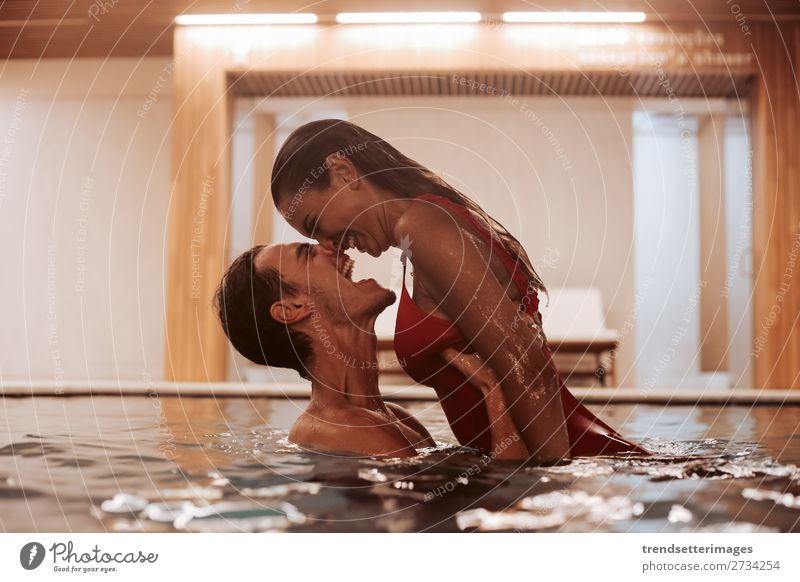 Couple In Love At Luxury Hotel Lifestyle Joy Happy Beautiful Wellness Relaxation Spa Swimming pool Leisure and hobbies Woman Adults Man Waterfall Smiling water