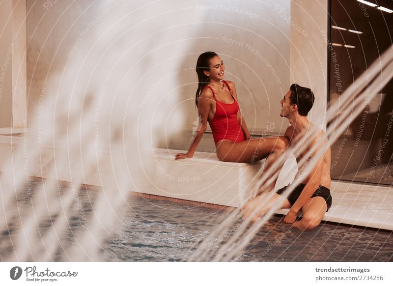 Couple In Love At Luxury Hotel Lifestyle Joy Happy Beautiful Wellness Relaxation Spa Swimming pool Leisure and hobbies Woman Adults Man Waterfall Smiling water