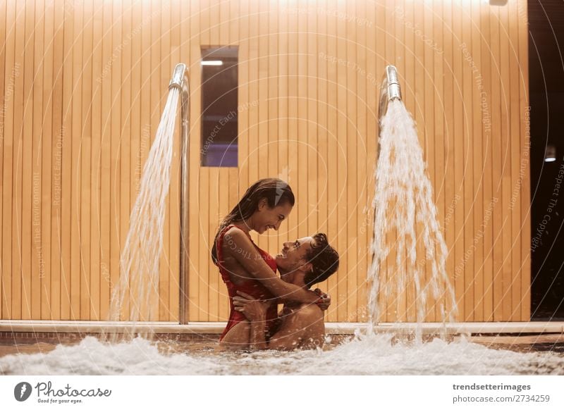 Couple In Love At Luxury Hotel Lifestyle Joy Happy Beautiful Wellness Relaxation Spa Swimming pool Leisure and hobbies Woman Adults Man Waterfall Smiling water