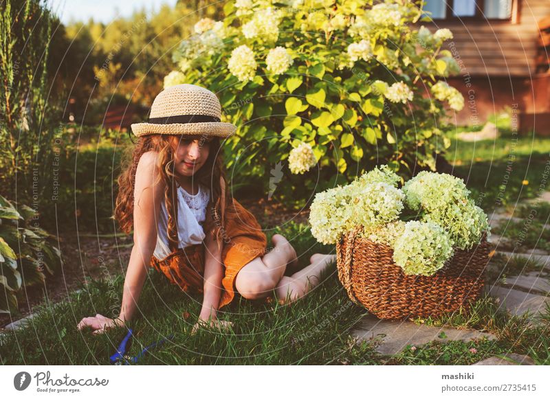 happy romantic kid girl playing and picking flowers Lifestyle Joy Harmonious Leisure and hobbies Summer Garden Child Gardening Environment Nature Landscape