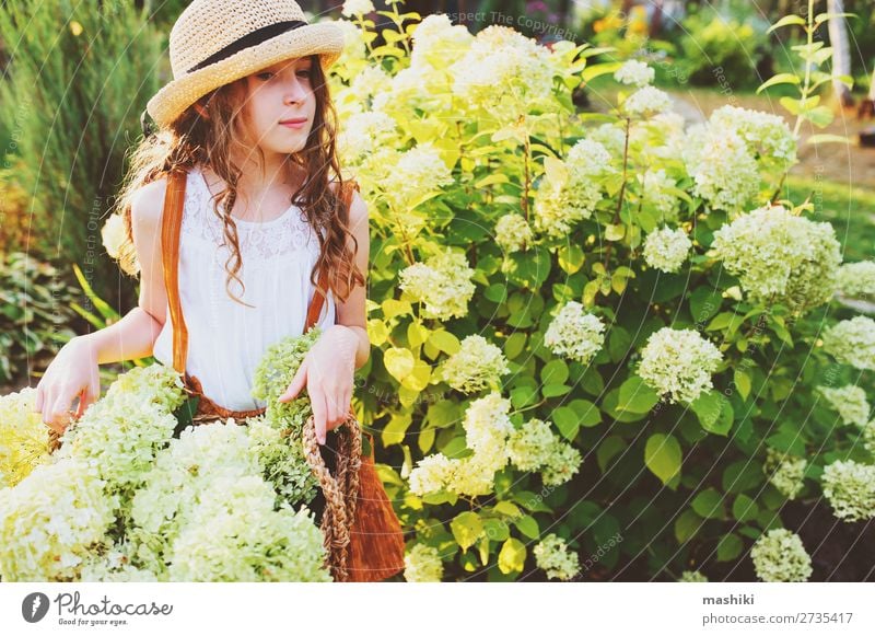 happy romantic kid girl playing and picking flowers Lifestyle Joy Harmonious Leisure and hobbies Summer Garden Child Gardening Environment Nature Landscape