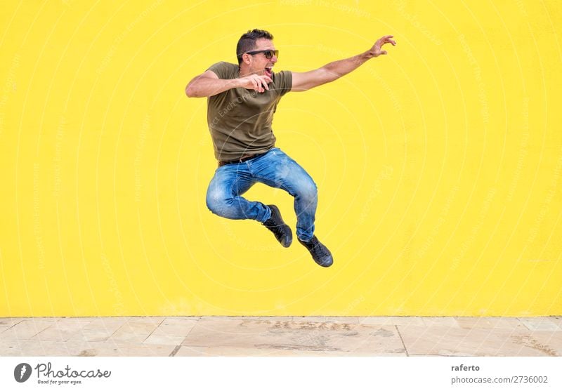 Front view of a young man wearing sunglasses jumping Lifestyle Style Joy Happy Human being Masculine Boy (child) Young man Youth (Young adults) Man Adults 1