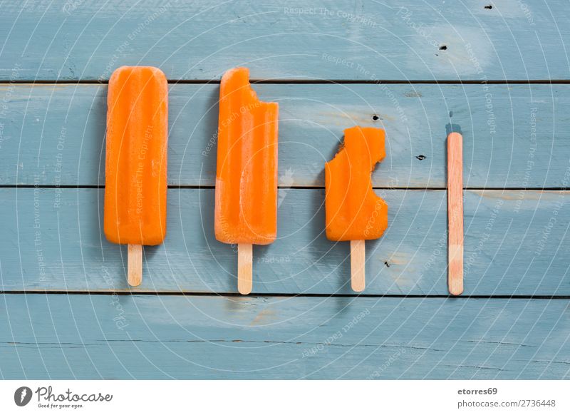 Orange popsicles on blue wooden cake Summer Ice Ice cream Cold Food Healthy Eating Food photograph Dessert Frozen Icing Vegan diet Cream bitten stick lolly