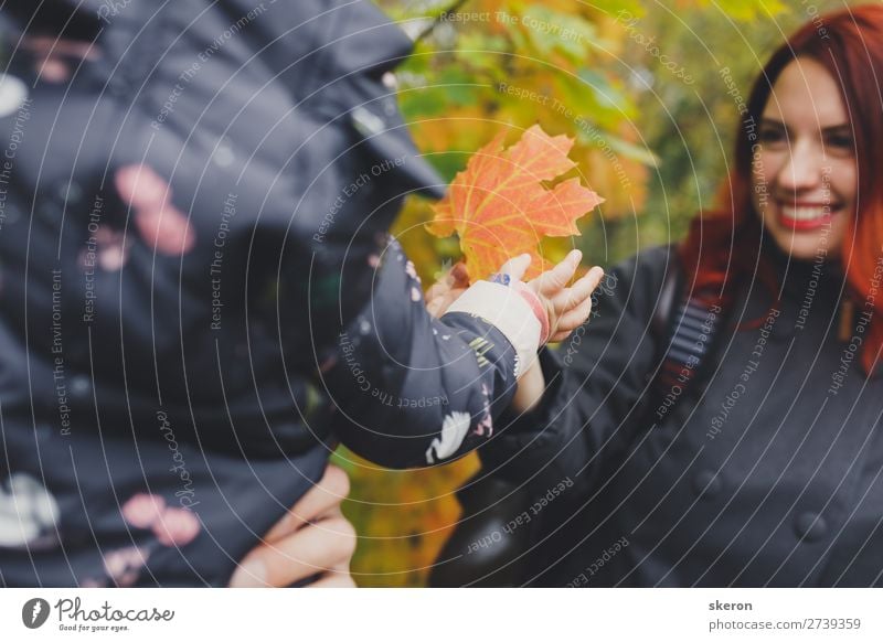 on the walk, the mother shows the child a maple leaf Lifestyle Healthy Health care Leisure and hobbies Playing Vacation & Travel Adventure City trip Human being