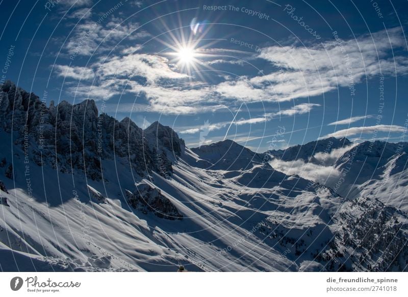 Mountain panorama in winter mountains Alps outlook Snow Sun Glare effect Sky Winter Clouds Blue Rock Ice Peak Panorama (View) Nature Landscape Exterior shot