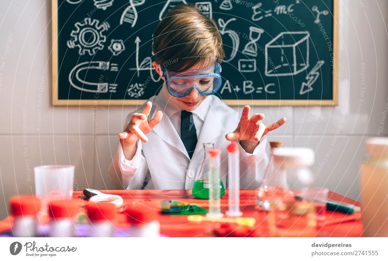 Boy playing with chemistry game Playing Science & Research Child School Blackboard Laboratory Human being Boy (child) Man Adults Tie Think Smart Interest