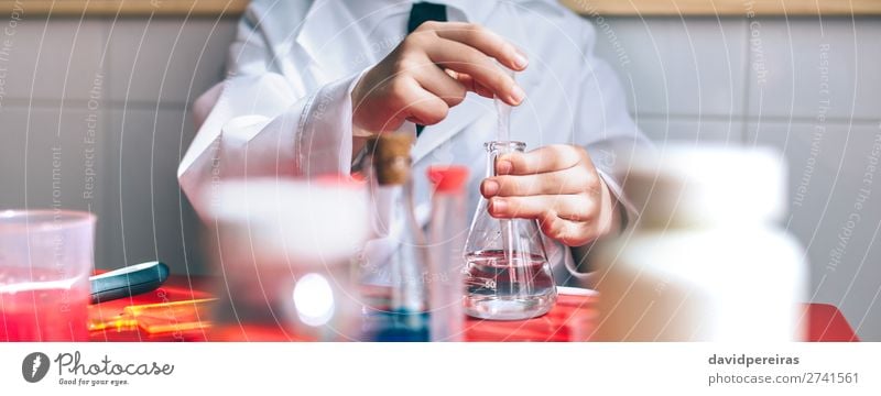 Serious kid playing with chemical liquids Bottle Playing Table Science & Research Child Classroom Blackboard Laboratory Internet Human being Boy (child) Infancy