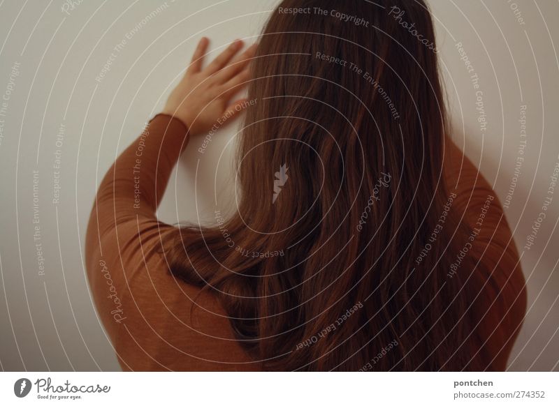 Rear view of a woman pressing her hands against a wall. Resisting, fighting Feminine Head Hair and hairstyles Back by hand 1 Human being Stand Pushing