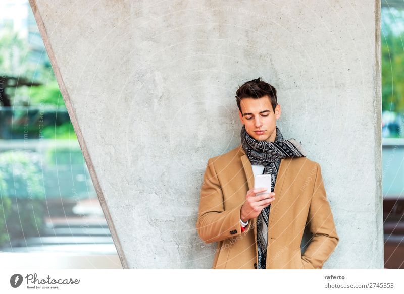 Young man wearing denim clothes using a mobile phone Lifestyle Elegant Style Beautiful Hair and hairstyles To talk Telephone PDA Human being Masculine