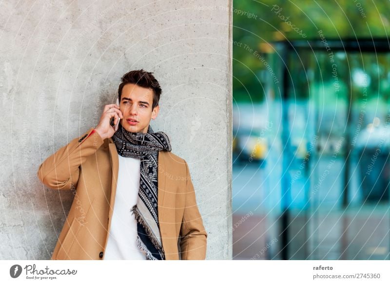 Young man wearing denim clothes using a mobile phone Lifestyle Elegant Style Beautiful Hair and hairstyles To talk Telephone PDA Human being