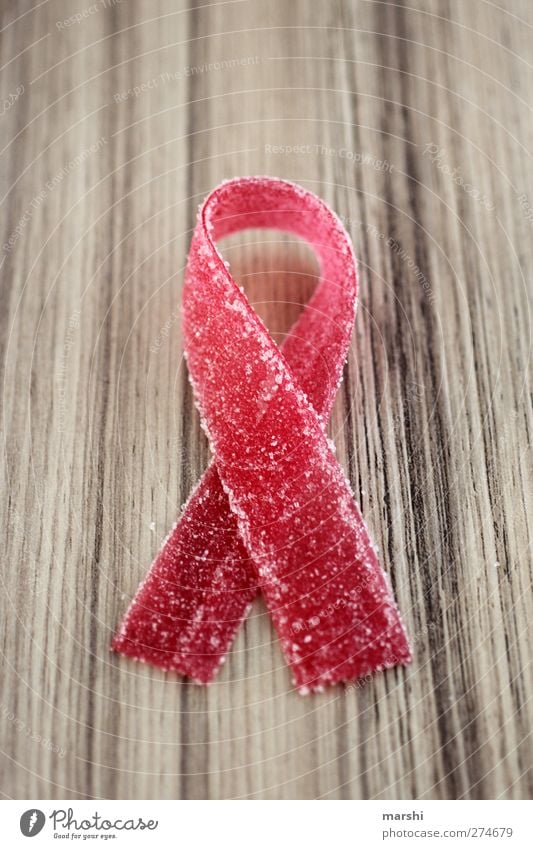 symbolic power Food Candy Nutrition Sign Red Symbols and metaphors Symbolism AIDS aid loop Bow World AIDS Day Illness Sweet Beautiful Colour photo Detail